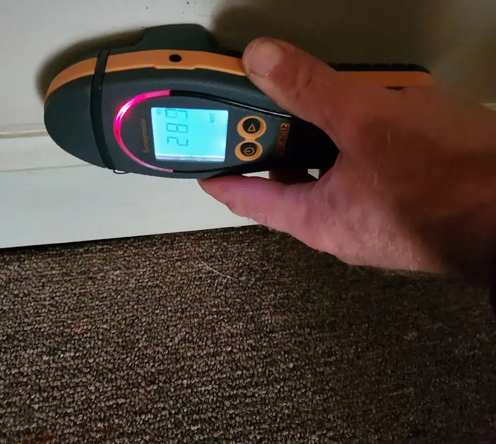 Moisture detection at baseboard during Storm Damage Restoration in Ennis